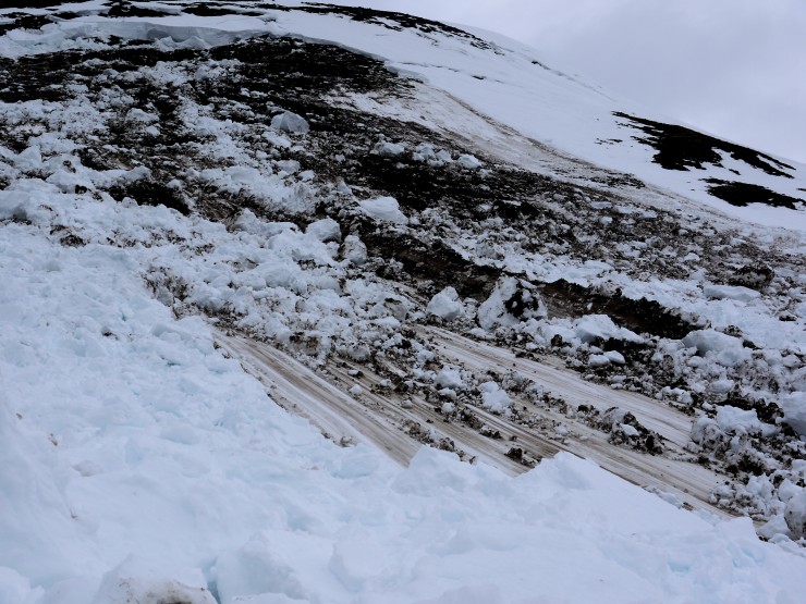 Glacial-like striations carved by the bigger mass of  upstream avalanche into the thinner downslope snow.
