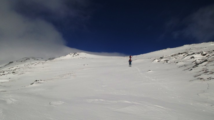 Heading up the Creag Mhor ridge on skis. Fine ski touring though snow surface is varied.