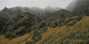 The mist covered (bare) mountains.